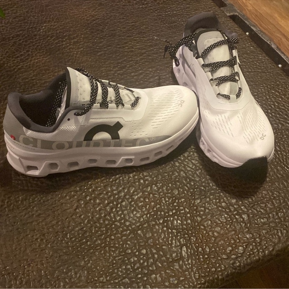 On Running White and Black Athletic Shoes